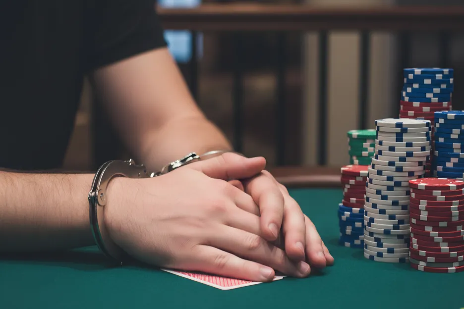 Poker player in handcuffs