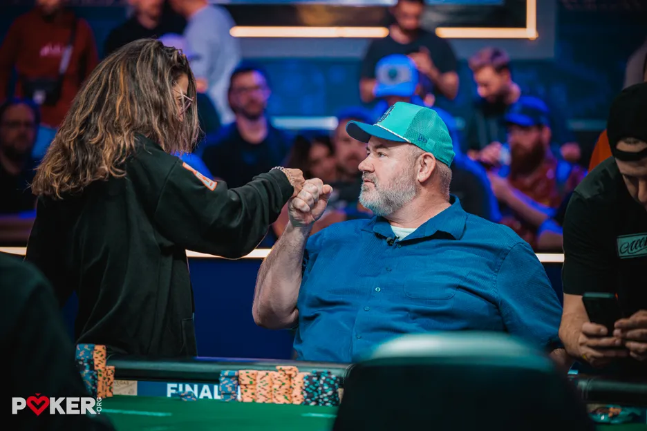 John Wasnock and Leo Margets congratulate one another as the remaining nine players bag up for the final table. 