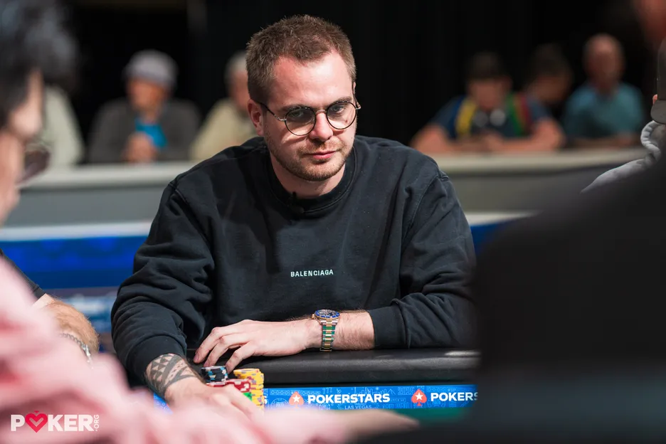 Romain Lacquet started building his huge stack against Jared Bleznick ojn Day 1.