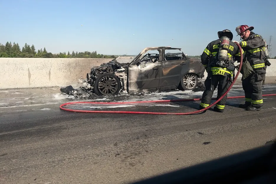 Kniep's burnt car on the side of a bridge in California. 